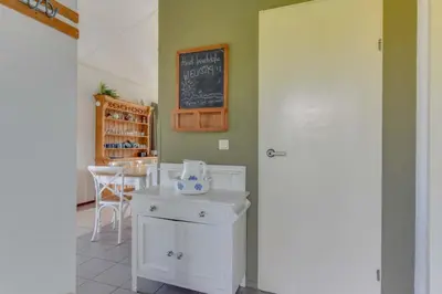 a kitchen with a table and a chalkboard on the wall at Rekerlanden 274 in Warmenhuizen