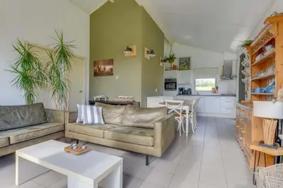 a living room with a couch and a table at Rekerlanden 274 in Warmenhuizen