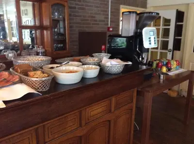 a counter with bowls of food on top of it at Hotel de Admiraal in Noordwijk aan Zee