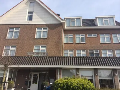 a brown brick building with white windows at Hotel de Admiraal in Noordwijk aan Zee