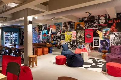 a room with chairs and posters on the wall at Stayokay Hostel Amsterdam Stadsdoelen in Amsterdam