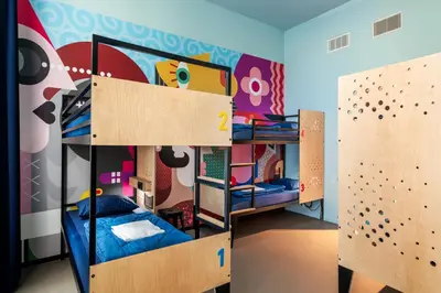 a bedroom with two bunk beds and a climbing wall at Stayokay Hostel Amsterdam Stadsdoelen in Amsterdam