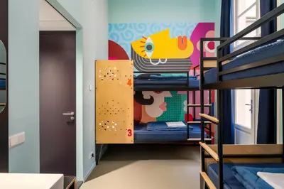 a room with bunk beds and a climbing wall at Stayokay Hostel Amsterdam Stadsdoelen in Amsterdam