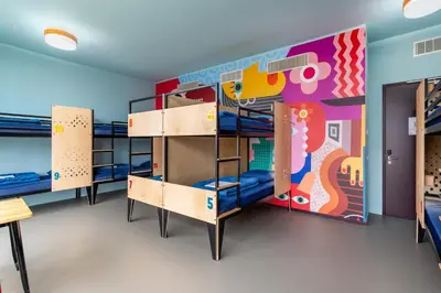 a room with bunk beds with a mural at Stayokay Hostel Amsterdam Stadsdoelen in Amsterdam