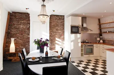 a kitchen and dining room with a table and chairs at Canal Holiday Apartment in Amsterdam