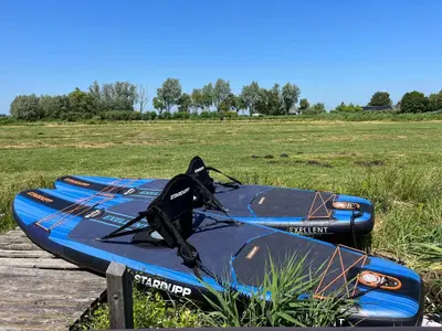 a blue kayak sitting on top of a field at Amsterdam The Stables in Oostzaan