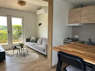 a kitchen and living room with a couch and a table at Amsterdam The Stables in Oostzaan