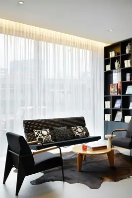 a living room with a couch and a coffee table at citizenM Schiphol Airport in Schiphol