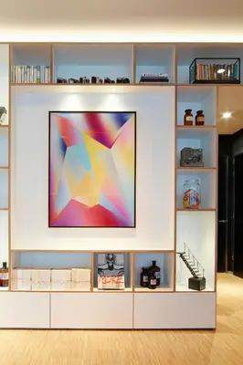 a flat screen tv on a white entertainment center at citizenM Schiphol Airport in Schiphol