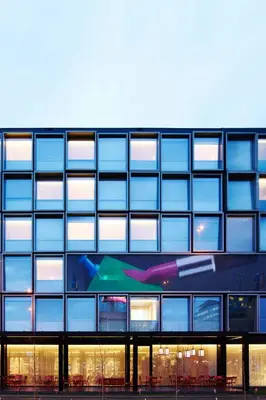 a building with a painting on the side of it at citizenM Schiphol Airport in Schiphol