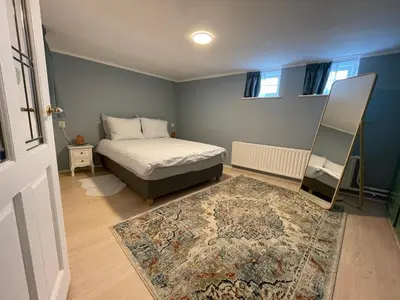 a bedroom with a bed and a rug at Strandzicht Zandvoort Boulevard Apartments in Zandvoort