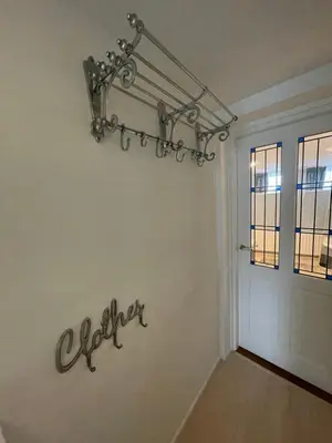 a chandelier hanging on a wall next to a door at Strandzicht Zandvoort Boulevard Apartments in Zandvoort