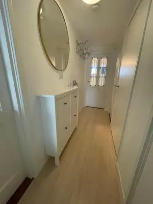 a bathroom with a sink and a mirror on the wall at Strandzicht Zandvoort Boulevard Apartments in Zandvoort