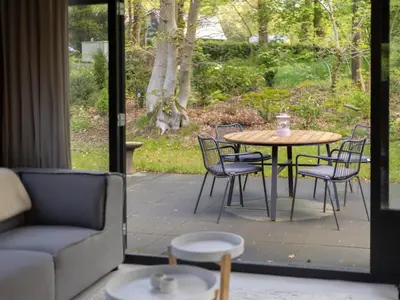a patio with a table and chairs and a couch at Amaryllis in Soesterberg