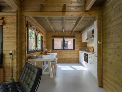 a kitchen with wooden walls and a table and chairs at Amaryllis in Soesterberg