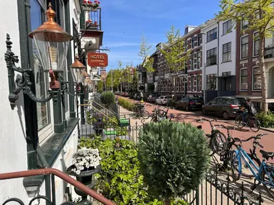 a city street with bikes parked on the sidewalk at Hotel Oorsprongpark City Centre Utrecht in Utrecht