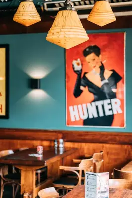 a sign on the wall in a restaurant with a table at Hotel Café Restaurant Abina in Amstelveen