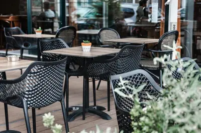 a group of tables and chairs at a restaurant at Hotel Café Restaurant Abina in Amstelveen