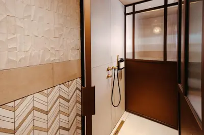 a bathroom with a shower and a door at The Diamond Amsterdam in Amsterdam