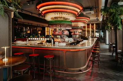 a bar with red stools in a restaurant at The Diamond Amsterdam in Amsterdam