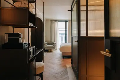 a hotel room with a bed and a bedroom at The Diamond Amsterdam in Amsterdam