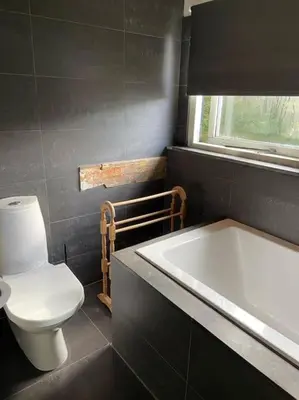 a bathroom with a white toilet and a bath tub at House on estate near Amsterdam and Keukenhof in Lisserbroek