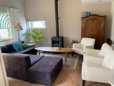 a living room with a couch and a table at House on estate near Amsterdam and Keukenhof in Lisserbroek