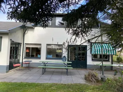 a building with a green bench in front of it at House on estate near Amsterdam and Keukenhof in Lisserbroek