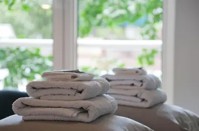a stack of towels sitting on top of a table at Bed & Breakfast WestViolet in Amsterdam