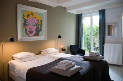 a bedroom with a large bed with towels on it at Bed & Breakfast WestViolet in Amsterdam