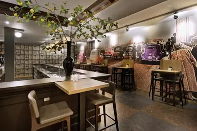 a restaurant with a bar with chairs and tables at Van der Valk Hotel Hilversum/ De Witte Bergen in Hilversum