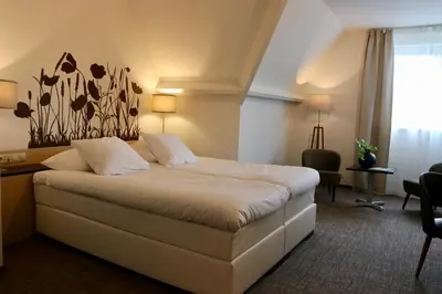 a hotel room with a large bed and a window at Van der Valk Hotel Hilversum/ De Witte Bergen in Hilversum