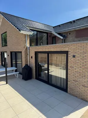 a sliding glass door on a brick building at Suite Dreamz in Zandvoort