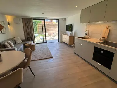 a kitchen and living room with a table and a couch at Suite Dreamz in Zandvoort