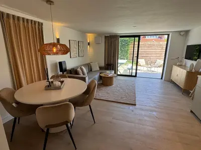 a living room with a table and chairs and a couch at Suite Dreamz in Zandvoort