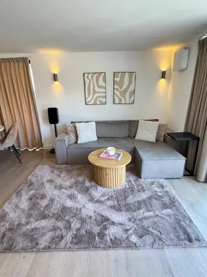 a living room with a couch and a table at Suite Dreamz in Zandvoort