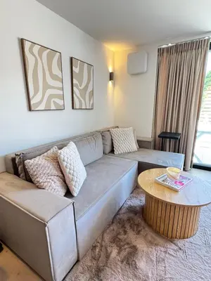 a living room with a couch and a table at Suite Dreamz in Zandvoort
