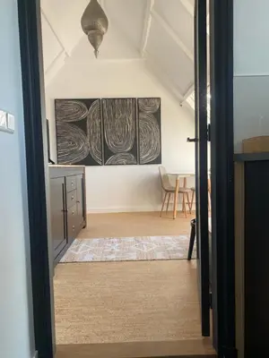 a room with two paintings on the wall at LONG BEACH ROOMS 3 in Zandvoort