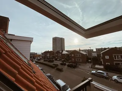a view of a parking lot from a balcony at LONG BEACH ROOMS 3 in Zandvoort
