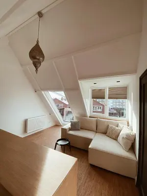 a living room with a couch and a table at LONG BEACH ROOMS 3 in Zandvoort