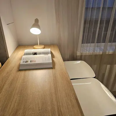 a book sitting on top of a table with a lamp at Charming Apartment in Lisse - 30 sqm with Terrace in Lisse
