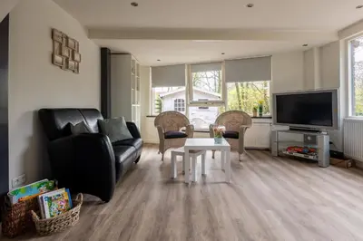 a living room with a couch and a table at Tulip Marina - garden sauna in Nieuwe-Niedorp