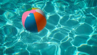 a colorful beach ball in a swimming pool at Tulip Marina - garden sauna in Nieuwe-Niedorp