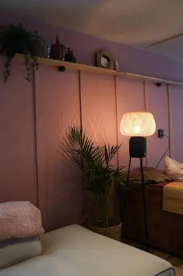 a bedroom with a lamp and a plant in it at Het Warme nest in Noordwijkerhout