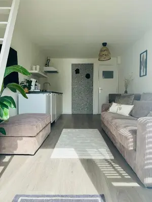 a living room with a couch and a table at Hello Noordwijk - Zomerhuis Quarles van Uffordstraat in Noordwijk aan Zee