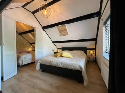 a bedroom with two beds in a room at Snijders cottage in Noordwijkerhout