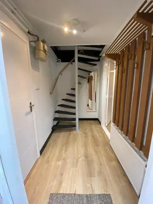 a hallway with a staircase in a room at Snijders cottage in Noordwijkerhout
