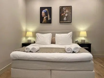 a bedroom with a large bed with towels on it at Amsterdam Grachtenappartement in Amsterdam