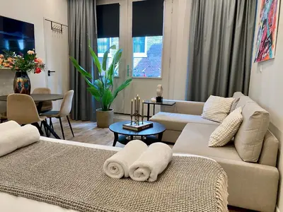 a living room with two couches and a dining room at Amsterdam Grachtenappartement in Amsterdam