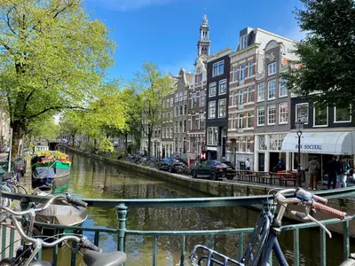 a group of bikes parked next to a canal at Amsterdam Grachtenappartement in Amsterdam